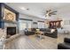 Open concept living room with a stone fireplace and a large sectional sofa at 16532 W Rowel Rd, Surprise, AZ 85387