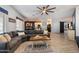 Bright living room with a sectional sofa and an open view of the dining and kitchen areas at 16532 W Rowel Rd, Surprise, AZ 85387