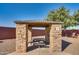 A covered picnic area with stone pillars and seating is perfect for outdoor gatherings and relaxation at 16532 W Rowel Rd, Surprise, AZ 85387