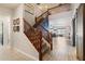 Elegant staircase showcasing wood-look tile floors and a view of the living space at 16532 W Rowel Rd, Surprise, AZ 85387