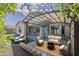 Inviting backyard with a pergola, stylish seating, and lush green lawn perfect for outdoor gatherings at 16830 W Magnolia St, Goodyear, AZ 85338