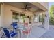Inviting covered patio with a ceiling fan and outdoor dining furniture for relaxing or entertaining at 16830 W Magnolia St, Goodyear, AZ 85338