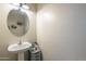 Simple and functional powder room with pedestal sink and neutral wall color at 16830 W Magnolia St, Goodyear, AZ 85338