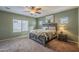 This spacious bedroom offers a ceiling fan, natural light, and neutral-toned walls at 16830 W Magnolia St, Goodyear, AZ 85338