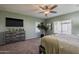 This spacious bedroom offers a ceiling fan, natural light, and stylish gray dresser at 16830 W Magnolia St, Goodyear, AZ 85338