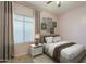 Bright bedroom featuring large window and stylish furniture at 16830 W Magnolia St, Goodyear, AZ 85338