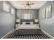 Well-lit bedroom featuring a ceiling fan, bedside tables and lamps, and soft carpet at 16830 W Magnolia St, Goodyear, AZ 85338