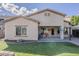Beautiful home exterior showcasing a manicured lawn, covered patio, and seamless indoor-outdoor living at 16830 W Magnolia St, Goodyear, AZ 85338