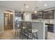 Stylish kitchen with dark cabinetry, granite countertops, and stainless steel appliances at 16830 W Magnolia St, Goodyear, AZ 85338