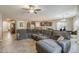 Comfortable living room with a large sectional sofa and tile flooring at 16830 W Magnolia St, Goodyear, AZ 85338