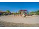 Safe and engaging playground area with soft surfaces, slides and play structures within the community at 16830 W Magnolia St, Goodyear, AZ 85338