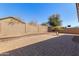 Fully fenced backyard featuring a brick paver patio, landscaping, and a calming desert vibe at 18072 W Vogel Ave, Waddell, AZ 85355