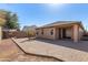 Well-maintained backyard with brick pavers, desert landscaping, and views of the home's rear exterior at 18072 W Vogel Ave, Waddell, AZ 85355