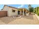 Spacious backyard with a covered patio, barbecue area, desert landscaping, and rock garden at 19140 N Tamarisk Flower Way, Surprise, AZ 85387