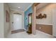 Welcoming foyer featuring tile flooring, accent wall, and decorative wall art at 19140 N Tamarisk Flower Way, Surprise, AZ 85387