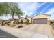 Attractive home featuring desert landscaping, stone accents, and a two-car garage at 19140 N Tamarisk Flower Way, Surprise, AZ 85387