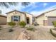 Inviting front exterior with desert landscaping, stone accents, and a well-maintained facade at 19140 N Tamarisk Flower Way, Surprise, AZ 85387