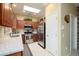 Well lit kitchen features a skylight, stainless steel appliances, light granite countertops, and wood cabinetry at 19140 N Tamarisk Flower Way, Surprise, AZ 85387