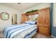 Bedroom features a large bed with built-in cabinetry and a view to the ensuite bath and walk-in closet at 19140 N Tamarisk Flower Way, Surprise, AZ 85387