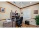 Home office with wood flooring, a built-in desk, and bright natural light at 19140 N Tamarisk Flower Way, Surprise, AZ 85387