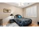 Cozy bedroom featuring shutters, neutral walls, wood floors, and overhead ceiling fan at 212 E Canary Ct, San Tan Valley, AZ 85143