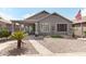 Back exterior featuring a covered patio, well-kept landscaping, and hardscaped backyard at 212 E Canary Ct, San Tan Valley, AZ 85143