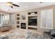 Comfortable living room featuring hardwood floors, built-in shelves, and a cozy fireplace at 212 E Canary Ct, San Tan Valley, AZ 85143