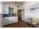 A functional room with storage cabinets, shelving, and a view into the adjacent bathroom at 2156 N Middlecoff Dr, Mesa, AZ 85215