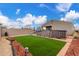 Backyard showcasing an above-ground pool, lush artificial turf, desert landscaping, and privacy fence at 21816 W Taft Ave, Wittmann, AZ 85361