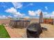 Backyard featuring a pool, artificial turf, gravel, and an outdoor grill for entertaining at 21816 W Taft Ave, Wittmann, AZ 85361