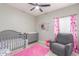 Cozy Bedroom featuring a crib, dresser, and comfortable seating area at 21816 W Taft Ave, Wittmann, AZ 85361