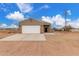 Inviting home exterior featuring a spacious driveway, stylish stone accents, and desert landscape at 21816 W Taft Ave, Wittmann, AZ 85361