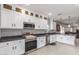 Bright kitchen features stainless steel appliances, stone countertops, and white cabinetry at 21816 W Taft Ave, Wittmann, AZ 85361