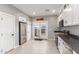 Modern kitchen boasts stainless appliances, stone counters, and white cabinets with backyard access at 21816 W Taft Ave, Wittmann, AZ 85361