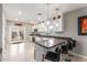 Modern kitchen with a breakfast bar, sleek countertops, stainless steel appliances, and stylish lighting at 21816 W Taft Ave, Wittmann, AZ 85361