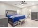 Comfortable main bedroom with ceiling fan, ensuite bathroom, and stylish furnishings at 21816 W Taft Ave, Wittmann, AZ 85361