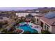 Aerial view features luxurious backyard with a pool, spa, built-in grill, and covered pergola at 2224 N 83Rd Cir, Mesa, AZ 85207