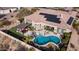Expansive aerial view of home featuring a pool, spa, covered patio and solar panels at 2224 N 83Rd Cir, Mesa, AZ 85207