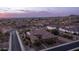 Sunset view of Southwestern home with tile roof and desert landscaping at 2224 N 83Rd Cir, Mesa, AZ 85207
