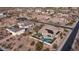 Wide aerial showcases pool, spa, and covered patio with a built-in grill, and putting green at 2224 N 83Rd Cir, Mesa, AZ 85207