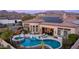 Aerial view showcases an outdoor oasis with pool, spa, patio, pergola, and solar panels at 2224 N 83Rd Cir, Mesa, AZ 85207
