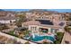 Gorgeous aerial view of the backyard featuring a sparkling pool, spa, and outdoor seating area at 2224 N 83Rd Cir, Mesa, AZ 85207
