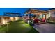 Beautiful backyard featuring a putting green, fire feature, and pergola-covered seating area at 2224 N 83Rd Cir, Mesa, AZ 85207