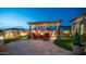 Inviting backyard with pergola, putting green, and travertine tile flooring creates an outdoor oasis at 2224 N 83Rd Cir, Mesa, AZ 85207