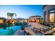 Resort-style backyard featuring a pool, spa, covered patio, and lounge chairs, ideal for outdoor living and entertaining at 2224 N 83Rd Cir, Mesa, AZ 85207