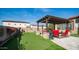 Expansive backyard with an outdoor kitchen, putting green, and comfortable seating area at 2224 N 83Rd Cir, Mesa, AZ 85207