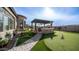 Large backyard with putting green, outdoor kitchen, and beautiful landscaping at 2224 N 83Rd Cir, Mesa, AZ 85207