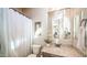 Charming bathroom with a single sink vanity, framed mirror, and a shower with a curtain at 2224 N 83Rd Cir, Mesa, AZ 85207
