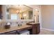 Elegant bathroom with a large mirror, granite countertops, and vanity area with dark wood cabinets at 2224 N 83Rd Cir, Mesa, AZ 85207