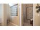 Luxurious bathroom with a glass block window and tiled shower with a decorative bench at 2224 N 83Rd Cir, Mesa, AZ 85207